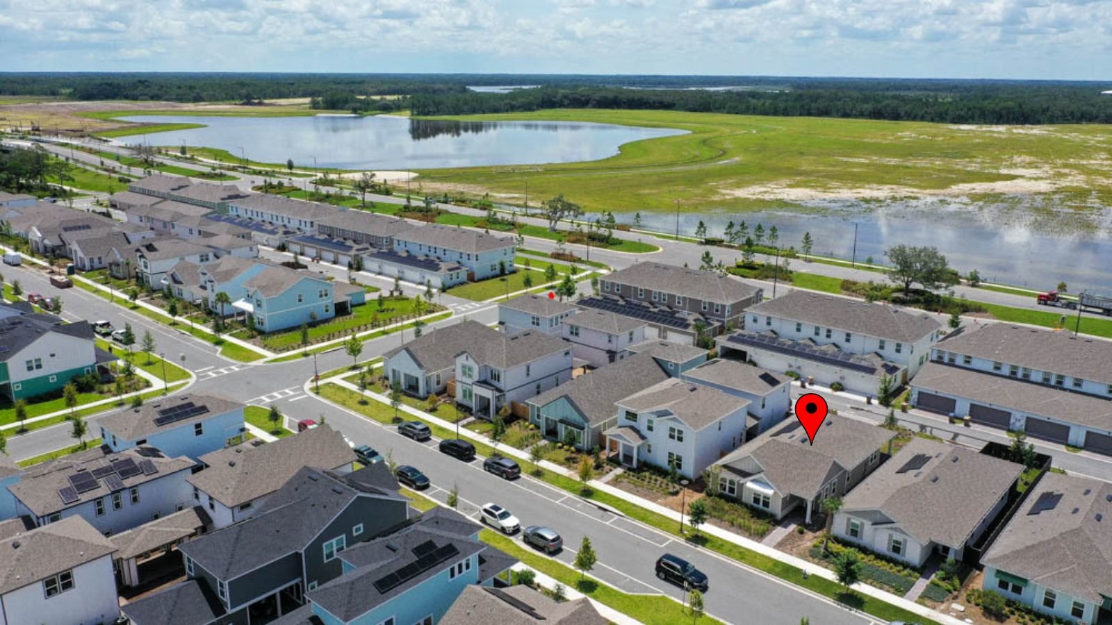 drone shot of home with red pinpoint